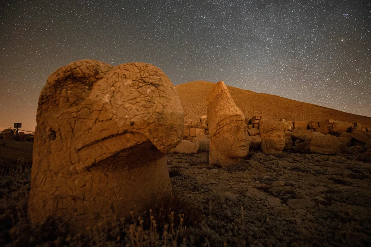 The toppled stone heads of gods and a king resting on the ground at Mount Nemrut